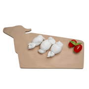 Three LEO Nodini fresh cow's milk cheese knots on a wooden cutting board with cherry tomatoes.