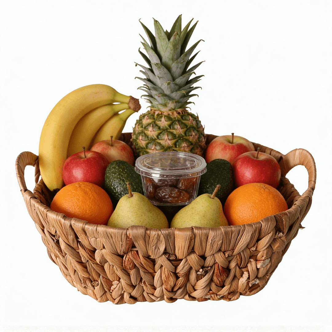 A beautifully arranged Energy Basket filled with fresh fruits including bananas, apples, oranges, and a pineapple.